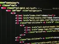 Fragment kodu HTML z listą nawigacyjną. Widać tagi `div`, `nav`, `ul`, `li` i `a`, tworzące strukturę strony.