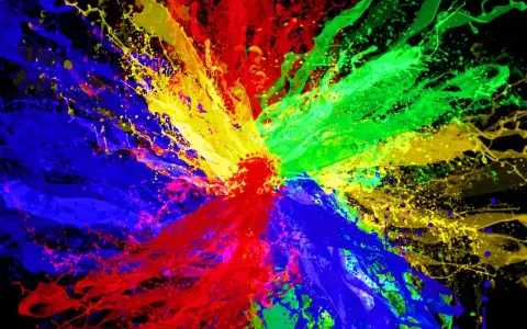 Eksplozja kolorów: czerwony, zielony i niebieski tworzą dynamiczną paletę kolorów RGB na czarnym tle.
