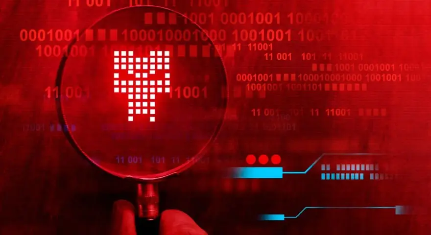 Pod lupą widać symbol przypominający czaszkę, symbolizujący **malware**. Tło to czerwony kod binarny, sugerujący zagrożenie cyfrowe.