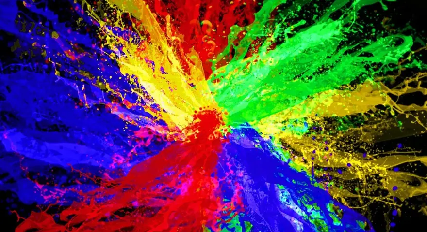 Eksplozja kolorów: czerwony, zielony i niebieski tworzą dynamiczną paletę kolorów RGB na czarnym tle.